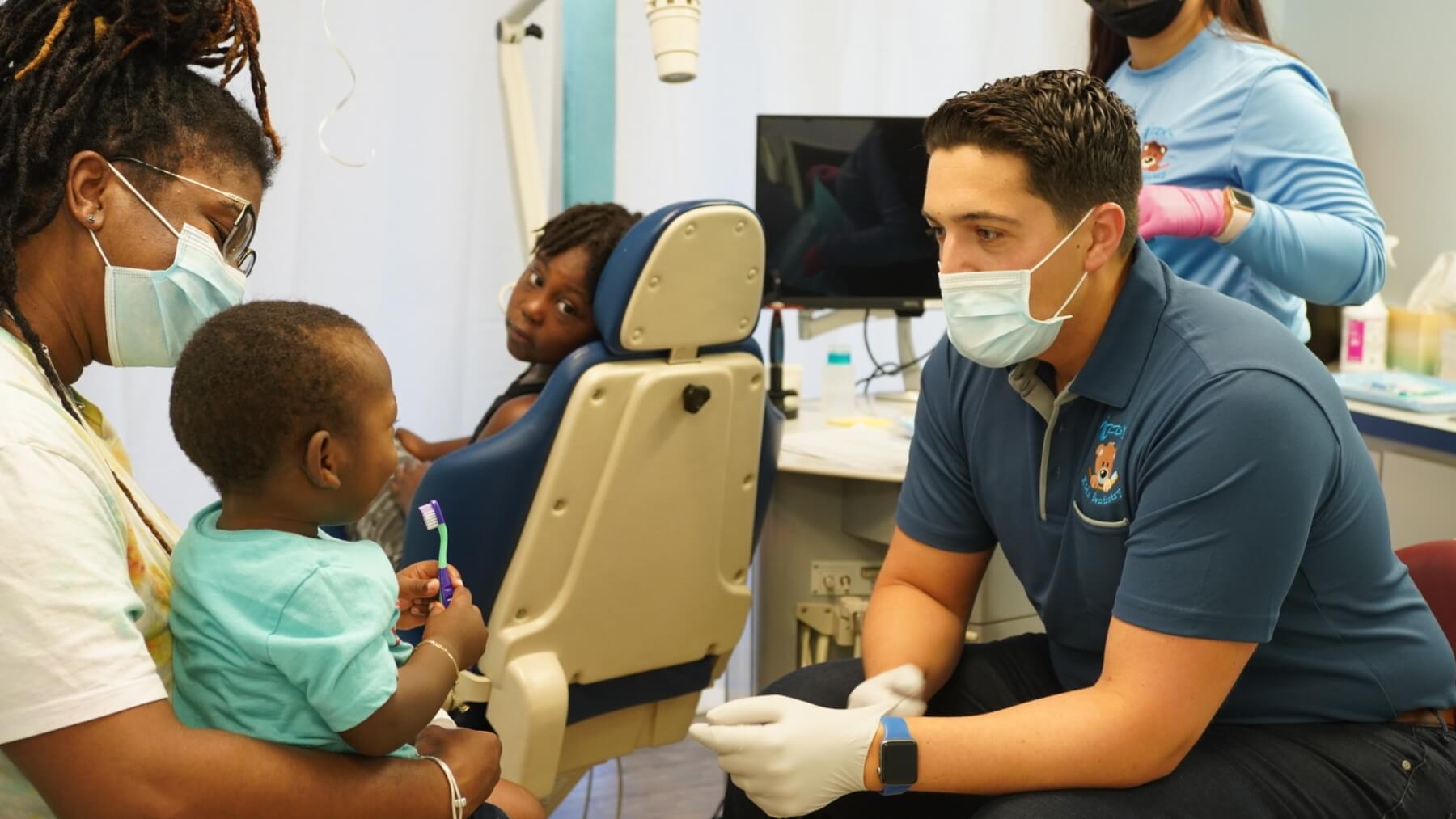 Dr. Izzy consulting with a parent - Izzy's Kidz Dentistry