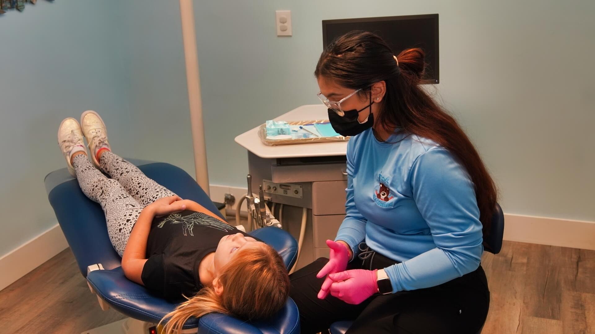 A patient and hygienist - Izzy's Kidz Dentistry